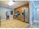 Spacious kitchen with stainless steel appliances, tile floor, and wooden cabinets at 1012 W New Hampshire St, Orlando, FL 32804
