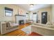 Cozy living room with a painted fireplace, hardwood floors, and ample seating at 1012 W New Hampshire St, Orlando, FL 32804