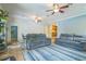 Bright living room with comfortable seating, a blue rug, and an open view to the kitchen at 1012 W New Hampshire St, Orlando, FL 32804