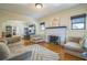 Bright living room with hardwood floors, fireplace, and ample natural light from large windows at 1012 W New Hampshire St, Orlando, FL 32804