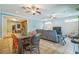 Open living room featuring tile floors, dining table, ceiling fans, and a gray sofa set at 1012 W New Hampshire St, Orlando, FL 32804