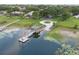 Stunning aerial view of a home with a private dock and boat lift on a serene lake surrounded by lush greenery at 10146 Pointview Ct, Orlando, FL 32836