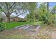 Lush backyard with mature trees and garden beds offers a serene and private outdoor space at 10146 Pointview Ct, Orlando, FL 32836