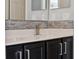 Bathroom vanity with stylish dark wood cabinets, light countertop, and mosaic backsplash at 10146 Pointview Ct, Orlando, FL 32836