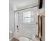 Bright bathroom with a white tiled shower and glass door, along with modern fixtures at 10146 Pointview Ct, Orlando, FL 32836