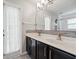 Modern bathroom featuring a double sink vanity, mosaic backsplash, and a glass door shower at 10146 Pointview Ct, Orlando, FL 32836