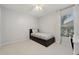 Cozy bedroom featuring neutral colors, a ceiling fan, and a window with natural light at 10146 Pointview Ct, Orlando, FL 32836
