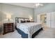 Serene bedroom with a comfortable bed, matching nightstands, and a view into the bathroom at 10146 Pointview Ct, Orlando, FL 32836