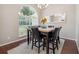 Cozy dining area with a marble table, leather chairs, and an arched window for natural light at 10146 Pointview Ct, Orlando, FL 32836