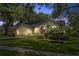 A cozy single-story home showcases its exterior, featuring manicured landscaping and nighttime illumination at 10146 Pointview Ct, Orlando, FL 32836