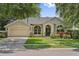 Charming single-story home with manicured lawn, arched windows, and attached two-car garage at 10146 Pointview Ct, Orlando, FL 32836