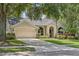 Charming single-story home with a manicured lawn, arched entryway, and attached two-car garage for modern comfort at 10146 Pointview Ct, Orlando, FL 32836