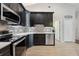 Updated kitchen features sleek black cabinets, stainless steel appliances, and stylish tile backsplash at 10146 Pointview Ct, Orlando, FL 32836
