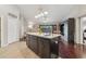Open-concept kitchen island with sink adjoins living area, offering a seamless entertaining space at 10146 Pointview Ct, Orlando, FL 32836