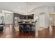 Spacious kitchen boasts dark cabinetry, a large island with seating, and stainless steel appliances at 10146 Pointview Ct, Orlando, FL 32836