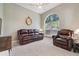 Comfortable living room with plush seating, a ceiling fan, and a large window overlooking the yard at 10146 Pointview Ct, Orlando, FL 32836