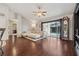 Bright living room featuring a cream couch, a grandfather clock, and access to the pool area at 10146 Pointview Ct, Orlando, FL 32836