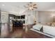 Open concept living area with dark wood floors, kitchen island, and comfortable seating at 10146 Pointview Ct, Orlando, FL 32836