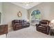 Comfortable living room with neutral walls, large window, and leather reclining sofa set at 10146 Pointview Ct, Orlando, FL 32836