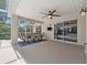 Spacious covered patio with dining and ceiling fan, leading to a screened pool area at 10146 Pointview Ct, Orlando, FL 32836