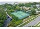 Aerial view of community tennis courts surrounded by lush greenery in a residential neighborhood at 10146 Pointview Ct, Orlando, FL 32836