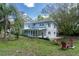Spacious backyard featuring a screened porch, patio area with seating, and lush greenery at 11 S University Cir, Deland, FL 32724