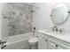 Updated bathroom with shower-tub combo, decorative tile and modern fixtures at 11 S University Cir, Deland, FL 32724