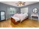 Cozy bedroom with ceiling fan, hardwood floors and lots of natural light at 11 S University Cir, Deland, FL 32724