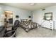 A cozy bedroom featuring a queen bed, white dresser with decorative mirror, and an office space at 11 S University Cir, Deland, FL 32724
