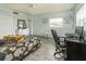 A cozy bedroom with wood-look floors, a large window and an office space at 11 S University Cir, Deland, FL 32724