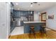 Well-appointed kitchen featuring an island with seating, stainless steel appliances, and hardwood floors at 11 S University Cir, Deland, FL 32724