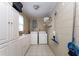 Functional laundry room with ample storage and modern washer and dryer at 11 S University Cir, Deland, FL 32724