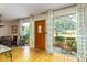 Bright entryway with hardwood floors, a large window, and a view into the dining area at 11 S University Cir, Deland, FL 32724