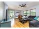 Spacious living room with hardwood floors, ceiling fan and natural light at 11 S University Cir, Deland, FL 32724