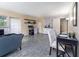 A cozy living room with wood-look floors, a dining area and small shelves at 11 S University Cir, Deland, FL 32724