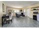 A cozy living room with wood-look floors, a dining area and fireplace at 11 S University Cir, Deland, FL 32724