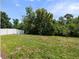 A spacious backyard features a well-maintained lawn and a white fence for privacy at 11218 Rouse Run Cir, Orlando, FL 32817