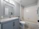 Neutral bathroom with a single sink vanity, standard bathtub with shower, and tiled floor at 11218 Rouse Run Cir, Orlando, FL 32817