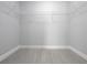 Empty walk-in closet with hanging shelves, light wood flooring, and neutral color paint at 11218 Rouse Run Cir, Orlando, FL 32817
