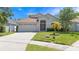 Charming single-story home with a well-manicured lawn and attached two-car garage at 11218 Rouse Run Cir, Orlando, FL 32817
