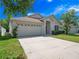 Charming single-story home with an attached two-car garage and well-manicured lawn at 11218 Rouse Run Cir, Orlando, FL 32817
