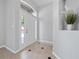 Inviting foyer featuring tile flooring, neutral paint, and a decorative niche with plants at 11218 Rouse Run Cir, Orlando, FL 32817