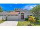 Charming one-story home with a well-manicured lawn, mature landscaping, and a two-car garage at 11218 Rouse Run Cir, Orlando, FL 32817