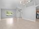 Inviting living room with tile flooring, neutral paint, arched doorway, and a view of the entryway at 11218 Rouse Run Cir, Orlando, FL 32817