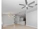 Open-concept living room with tile flooring, modern lighting, and neutral paint, creating a bright and airy space at 11218 Rouse Run Cir, Orlando, FL 32817