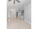Open-concept living room with tile flooring, modern lighting, and neutral paint, creating a bright and airy space at 11218 Rouse Run Cir, Orlando, FL 32817