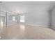 Spacious living room with neutral paint, tile flooring, arched doorway, and natural light at 11218 Rouse Run Cir, Orlando, FL 32817