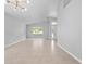 Inviting living room with tile flooring, neutral paint, arched doorway, and natural light streaming through the windows at 11218 Rouse Run Cir, Orlando, FL 32817