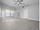 Spacious main bedroom with light wood flooring, ceiling fan, ensuite bathroom, and a large closet at 11218 Rouse Run Cir, Orlando, FL 32817