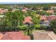 An aerial view of a home shows a well-manicured lawn and a beautiful tile roof at 11316 Rapallo Ln, Windermere, FL 34786